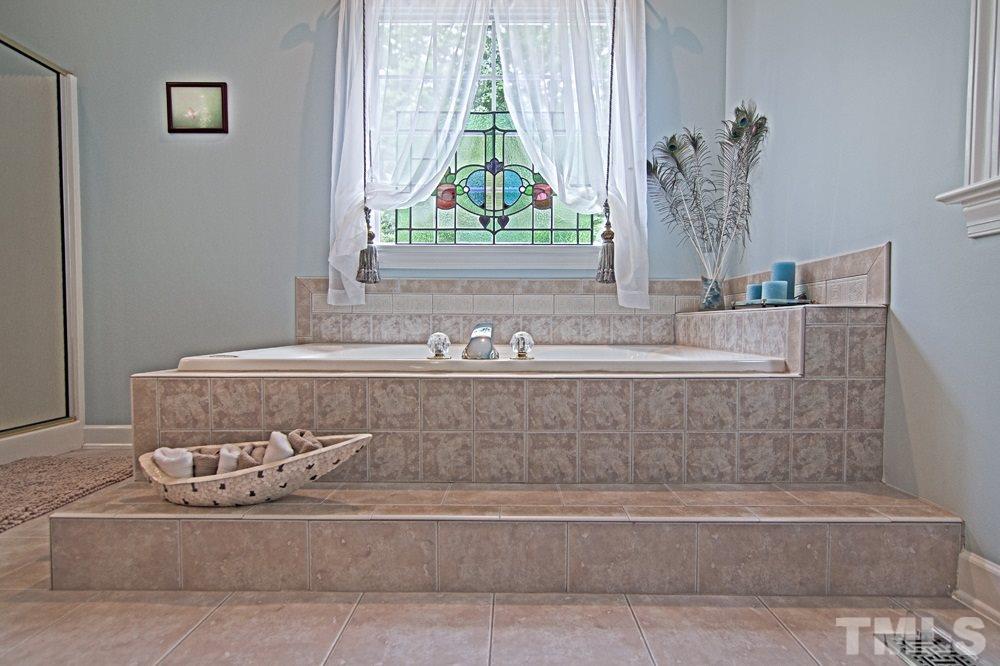 5305 Corbarron Court Raleigh, NC 27606 - Photo 15 of 21 Relax in this beautiful Jacuzzi tub overlooking private back yard, pool and landscaping