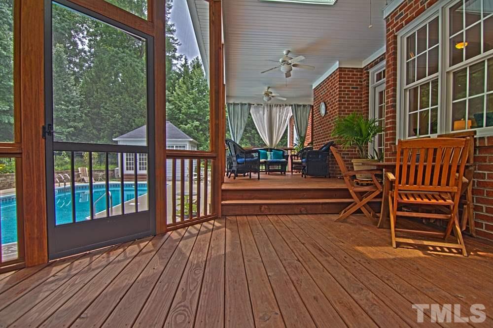 Entertain all of your friends on this custom screened porch overlooking the pool and lush landscaping