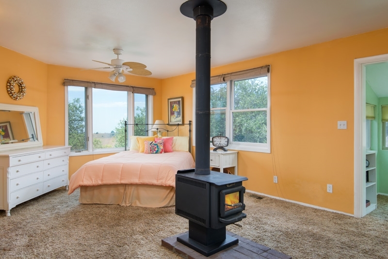 3255 Pine Hills Road Julian, CA 92036 - Photo 13 of 25 Master bedroom with cozy wood stove.