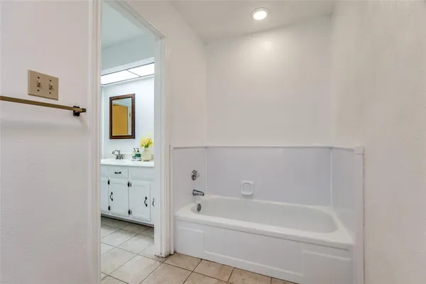 a bathroom with a bathtub and a sink