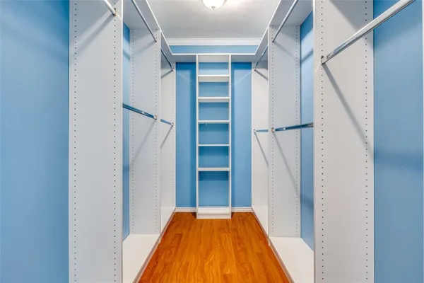 a view of a hallway with wooden floor and entryway
