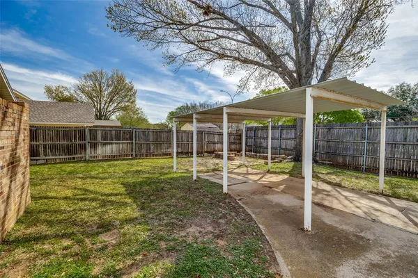 a view of a house with backyard and porch