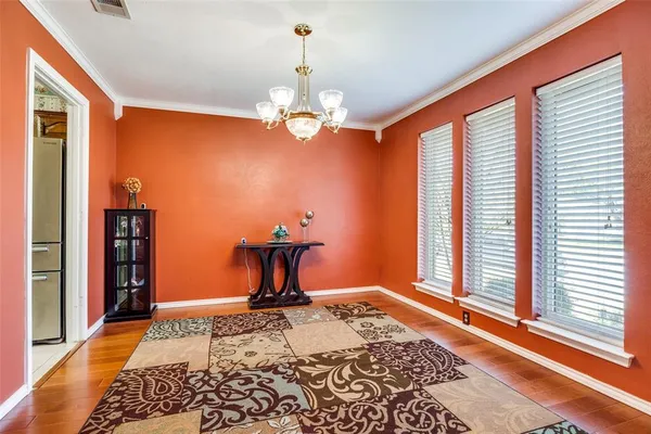 a bedroom with furniture a chandelier and a window