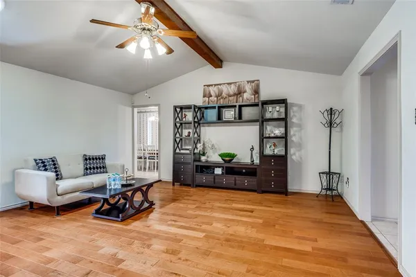 a living room with furniture a rug and a chandelier