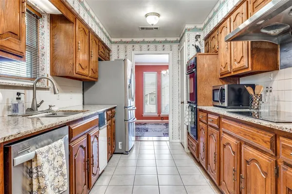 a kitchen with stainless steel appliances granite countertop a sink and cabinets