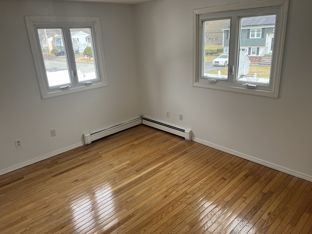 58 Brunswick Street Lowell, MA 01852 - Photo 14 of 33 an empty room with wooden floor and windows