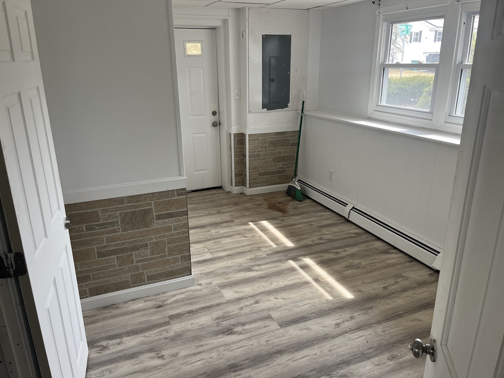 58 Brunswick Street Lowell, MA 01852 - Photo 18 of 33 an empty room with wooden floor and windows
