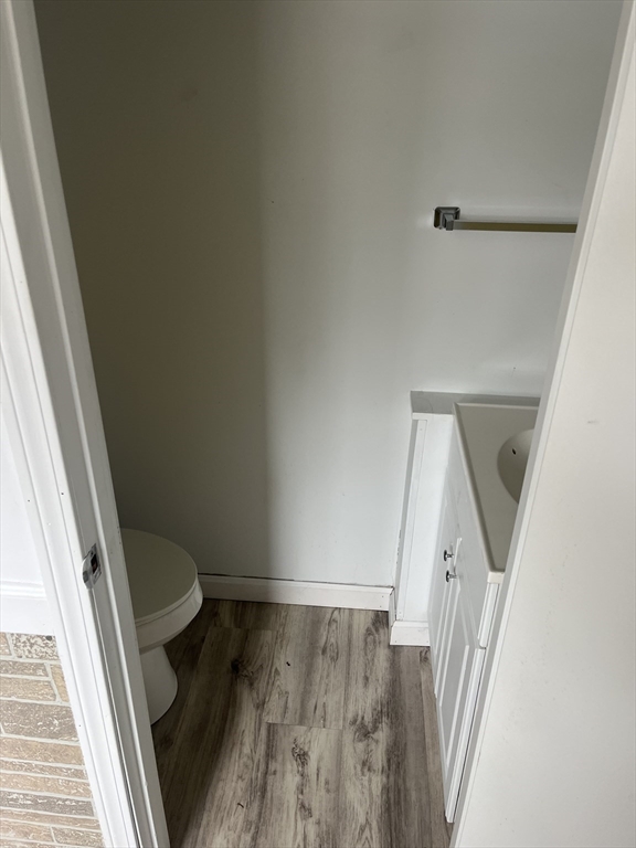 58 Brunswick Street Lowell, MA 01852 - Photo 19 of 33 a view of a hallway with wooden floor and staircase