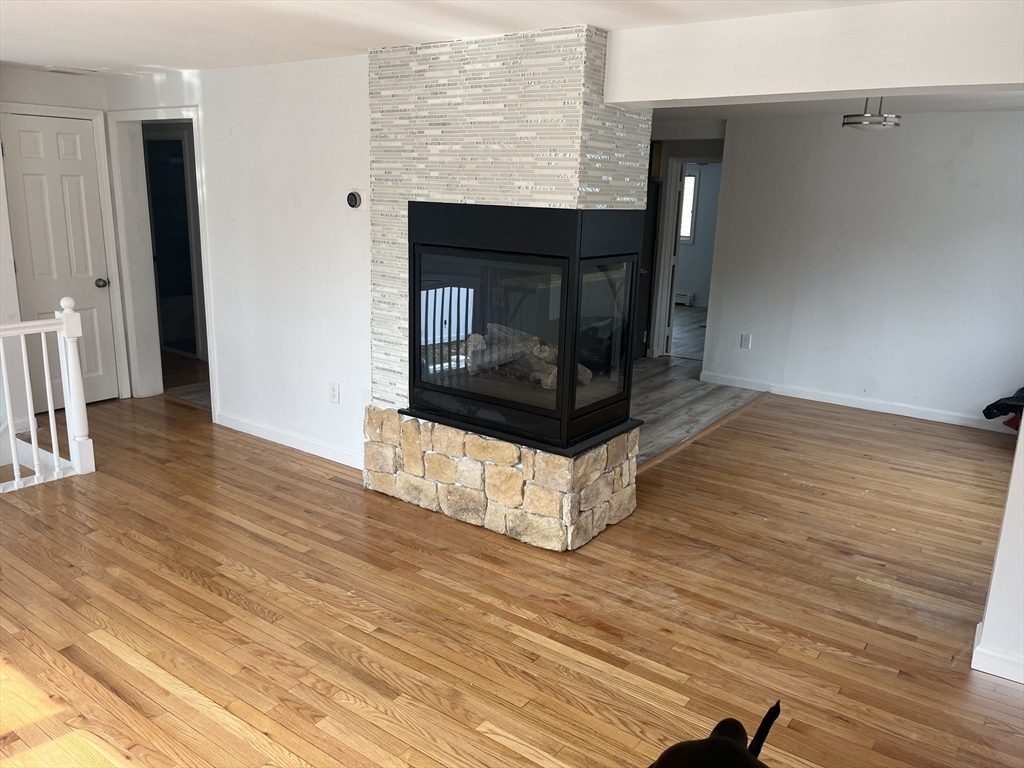 58 Brunswick Street Lowell, MA 01852 - Photo 2 of 33 a living room with a wooden floor