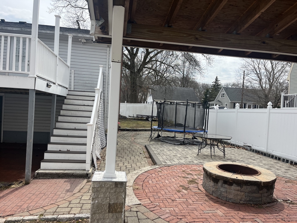 58 Brunswick Street Lowell, MA 01852 - Photo 33 of 33 a view of a chair and tables in backyard of the house