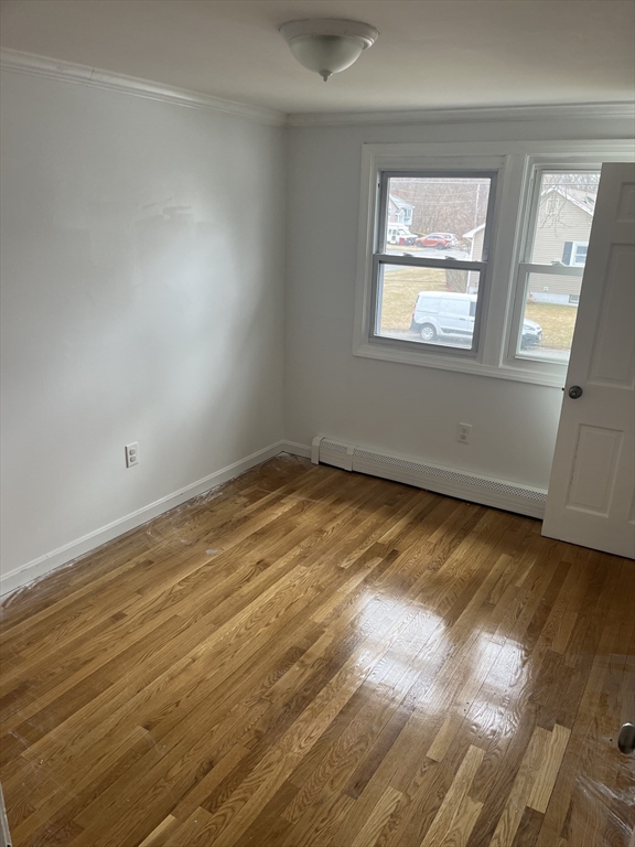 58 Brunswick Street Lowell, MA 01852 - Photo 8 of 33 a view of an empty room with wooden floor and a window