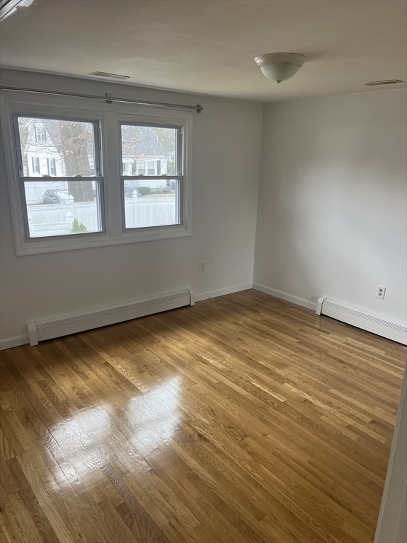 58 Brunswick Street Lowell, MA 01852 - Photo 9 of 33 wooden floor in an empty room with a window