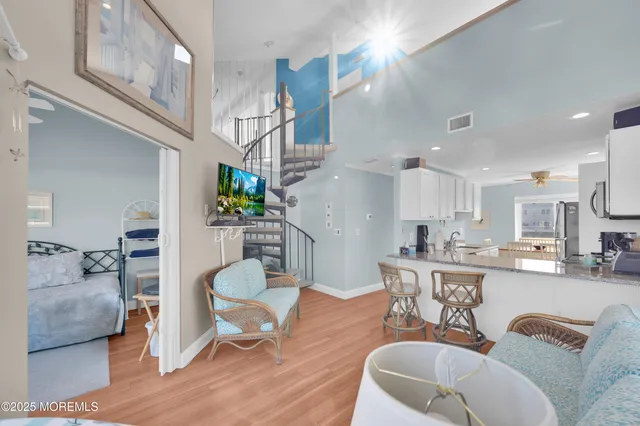 a living room with furniture a flat screen tv and a large window