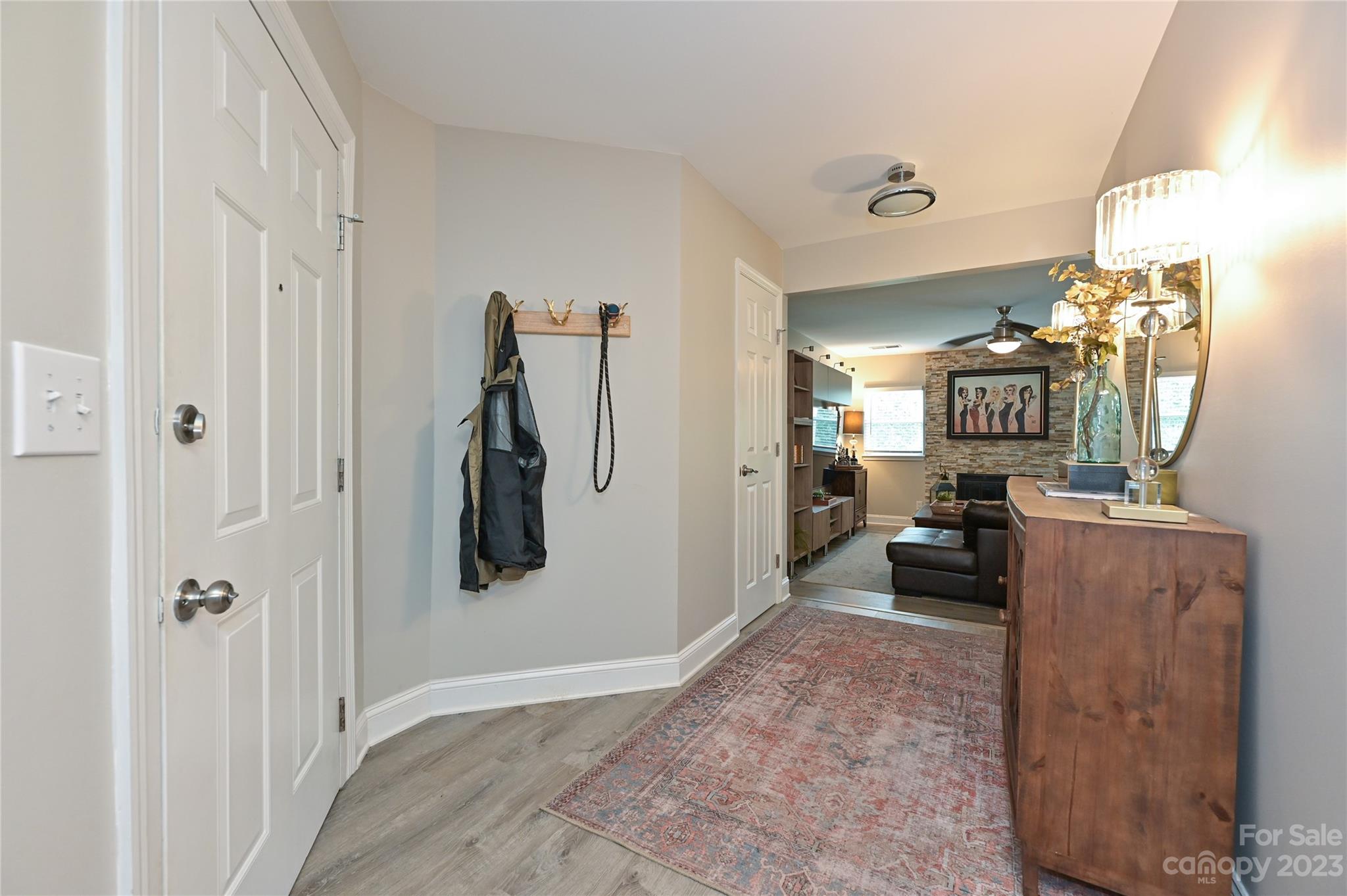 20109 Henderson Road, Unit D Cornelius, NC 28031 - Photo 2 of 18 a view of a hallway and a livingroom with furniture