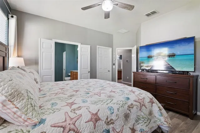 a bedroom with a bed and a flat screen tv