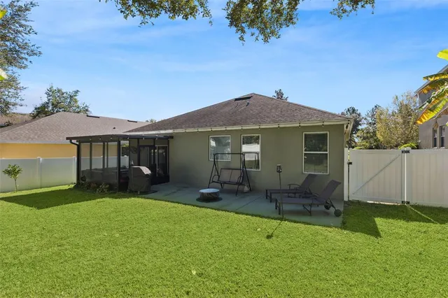 a backyard of a house with table and chairs
