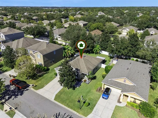 an aerial view of multiple houses with yard