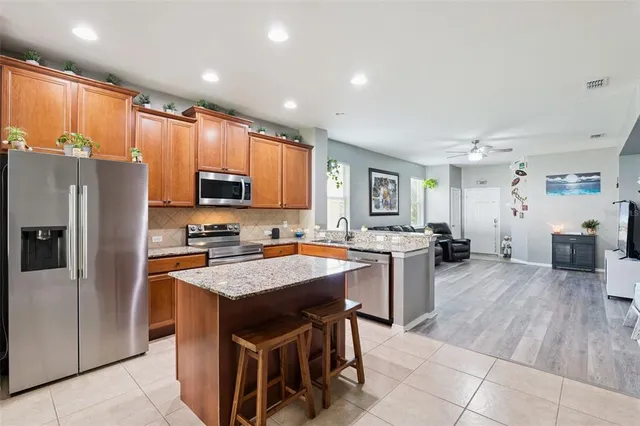 a kitchen with a sink a counter top stainless steel appliances and cabinets