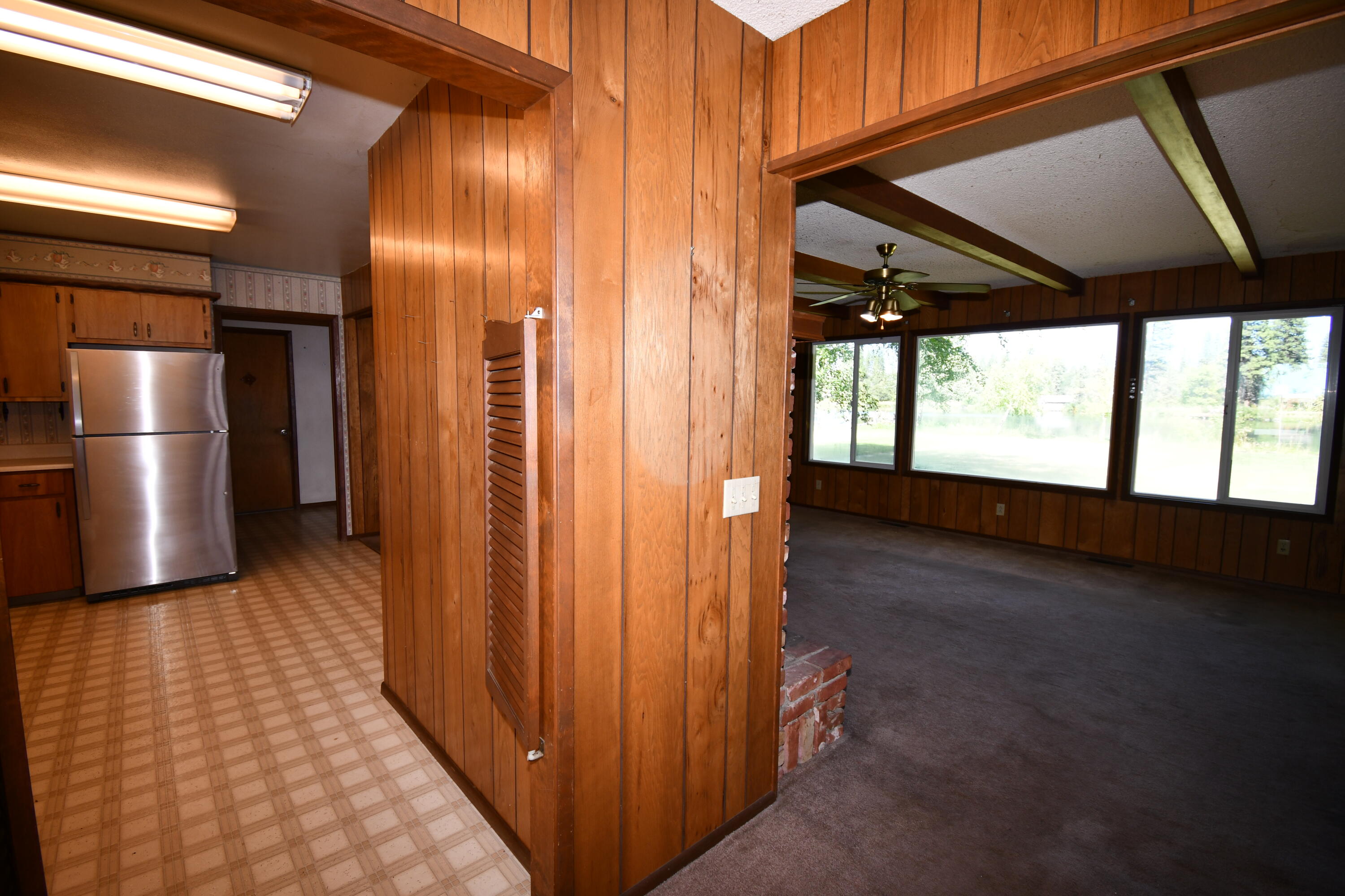 41916 Creighton Road Fall River Mills, CA 96028 - Photo 11 of 50 a view of hallway with a large window and wooden floor