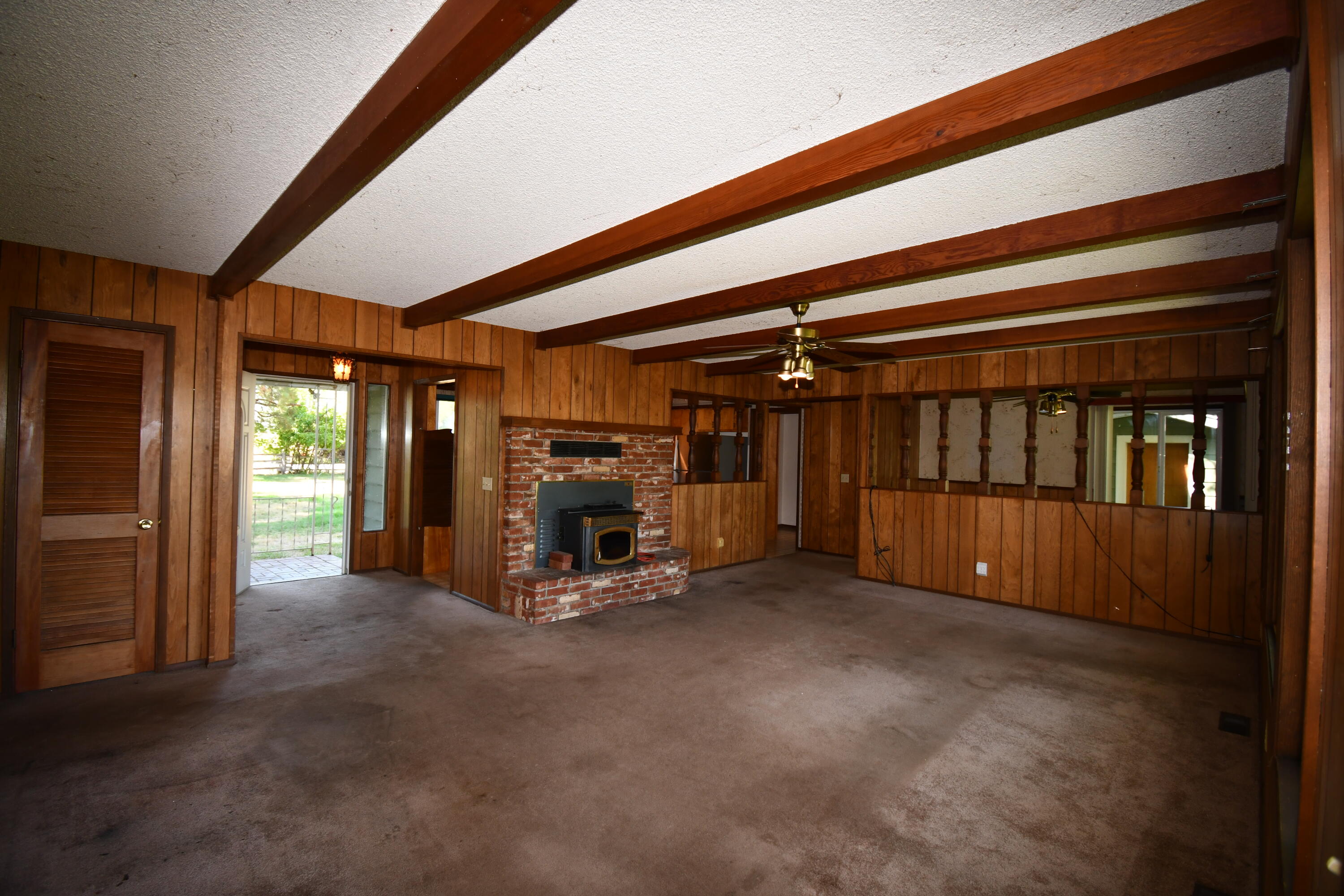 41916 Creighton Road Fall River Mills, CA 96028 - Photo 15 of 50 a view of an empty room with window and fireplace