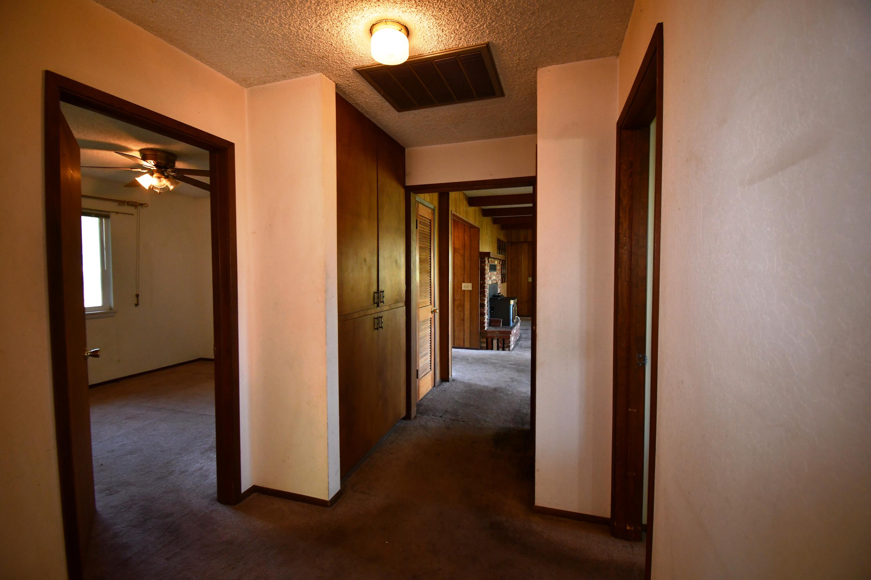41916 Creighton Road Fall River Mills, CA 96028 - Photo 21 of 50 a view of a hallway with some storage