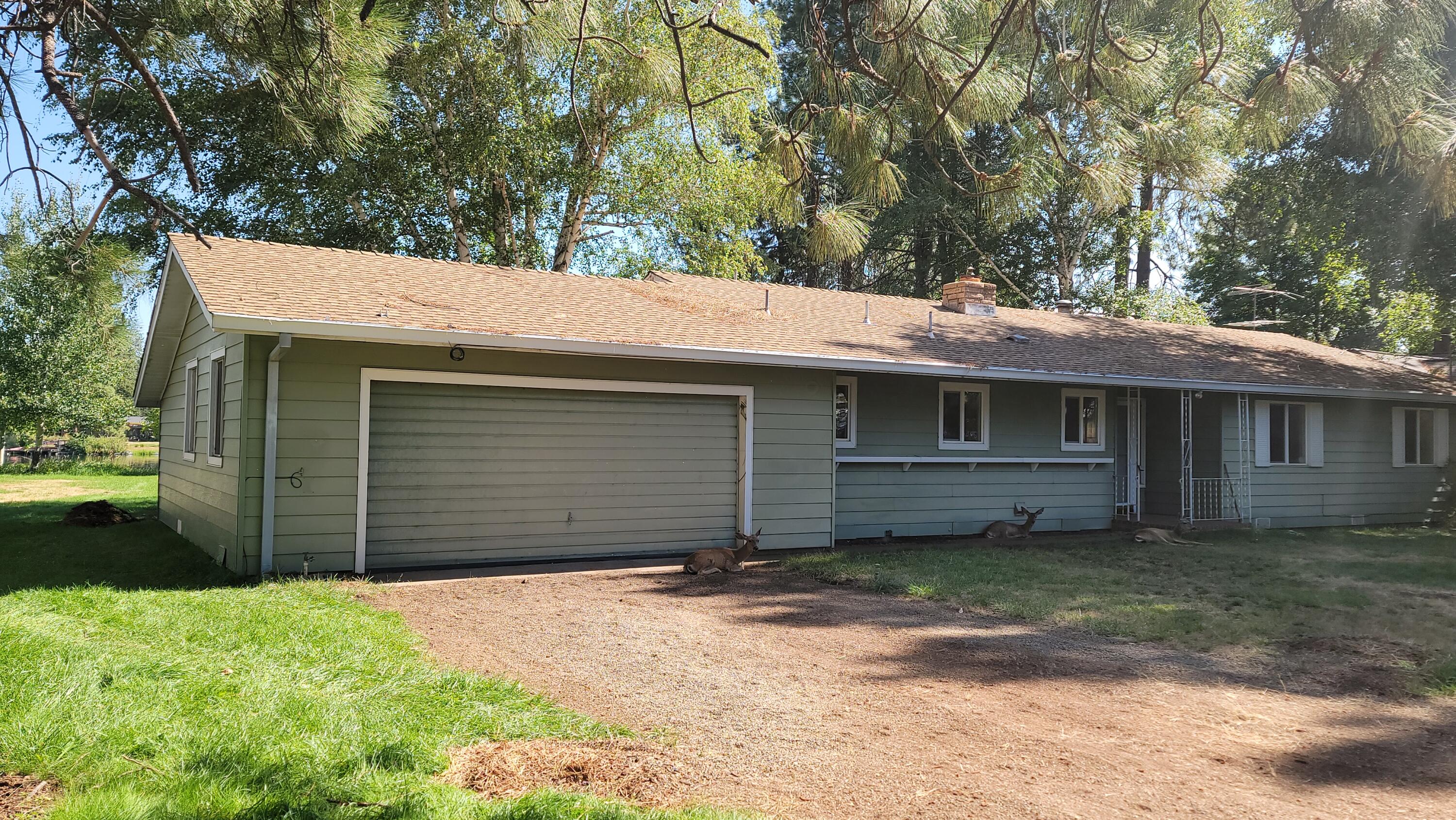 41916 Creighton Road Fall River Mills, CA 96028 - Photo 7 of 50 a view of a house with a yard and garage
