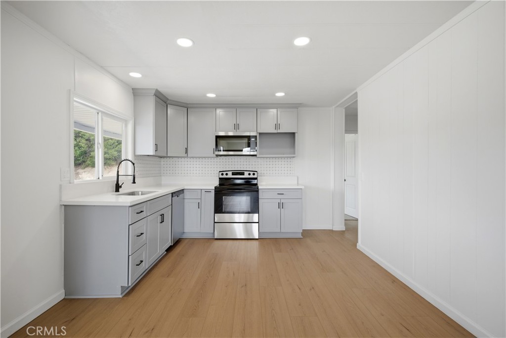 59995 Granite Gulley Road Anza, CA 92539 - Photo 8 of 33 a kitchen with granite countertop a refrigerator stove top oven and sink