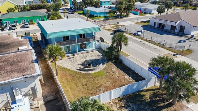 a view of a house with pool and sitting area