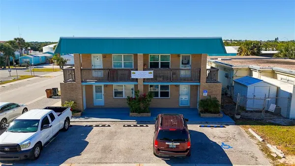 a front view of a house with sitting area