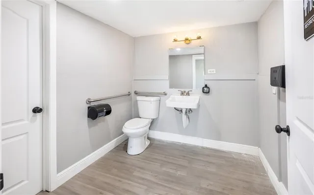 a white toilet sitting next to a bathroom sink