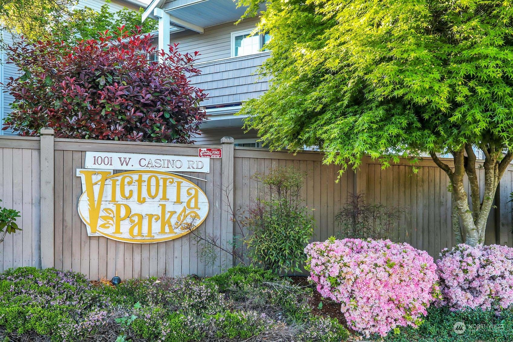 1001 West Casino Road, Unit C103 Everett, WA 98204 - Photo 18 of 23 a wooden fence with trees in the background