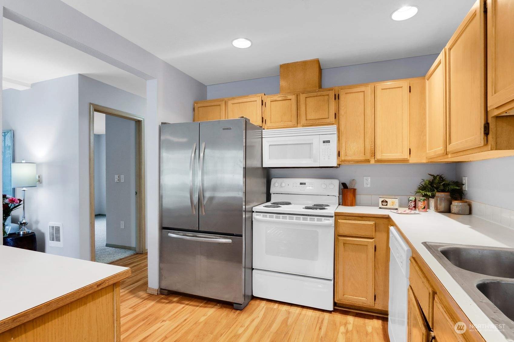 1001 West Casino Road, Unit C103 Everett, WA 98204 - Photo 6 of 23 a kitchen with a refrigerator sink and cabinets