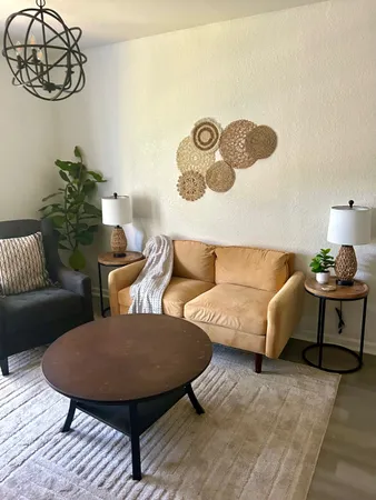 a living room with furniture and a lamp