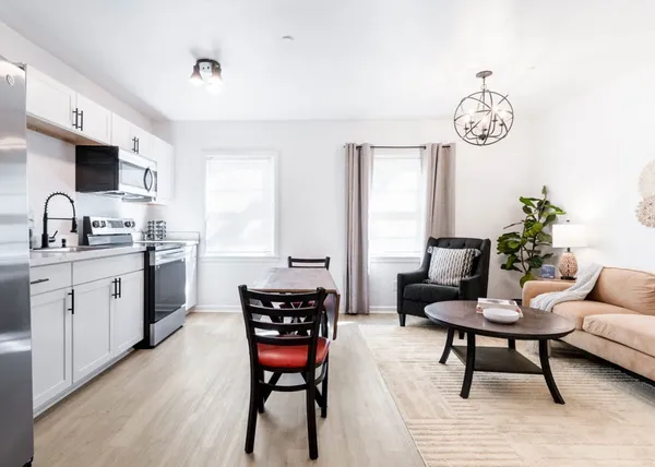 a view of kitchen with sink dining table and chairs