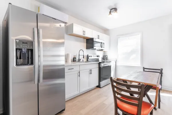 a kitchen with a refrigerator a sink and cabinets