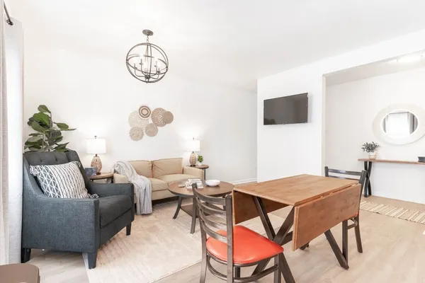 a living room with furniture a rug and a window