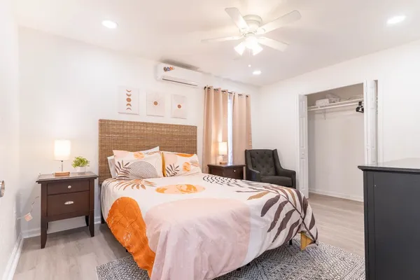 a bedroom with a bed and a chandelier