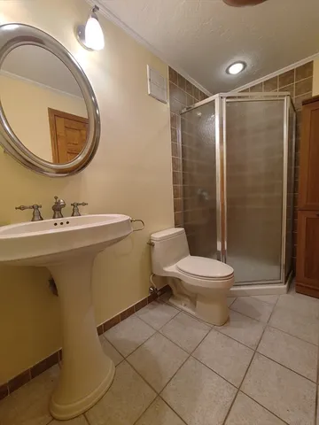 a white toilet sitting next to a bathroom sink