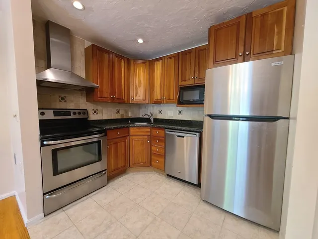 a kitchen with a sink stove and refrigerator