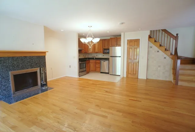a view of a kitchen with a sink and a fireplace