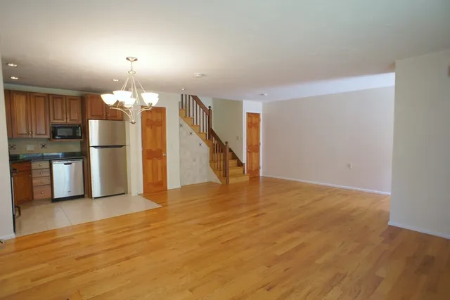 a view of a kitchen with a sink and a refrigerator