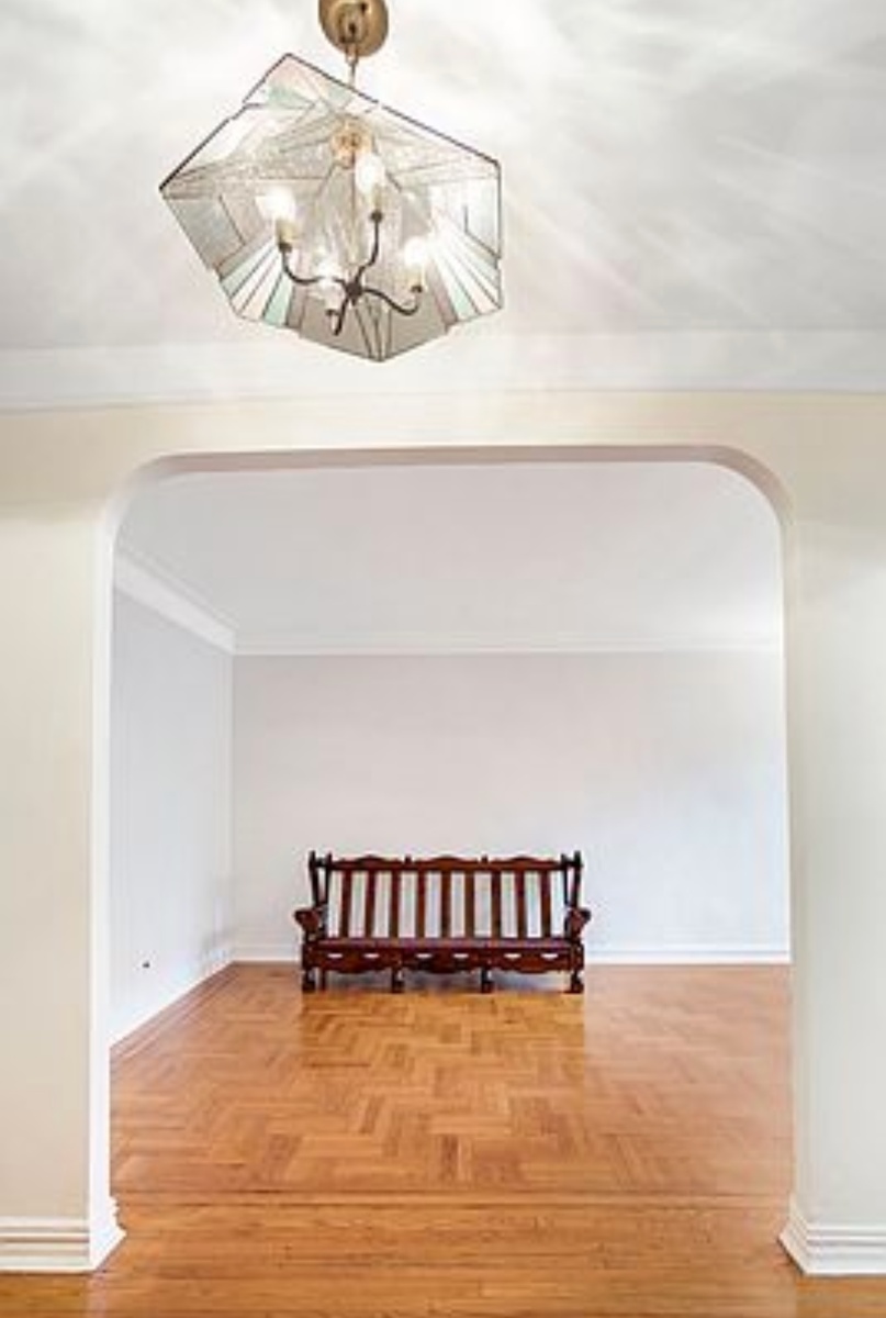 79-01 35th Avenue, Unit 4F Queens, NY 11372 - Photo 4 of 11 a view of a room with cabinet and a projector