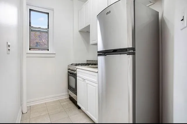 a utility room with cabinets washer and dryer