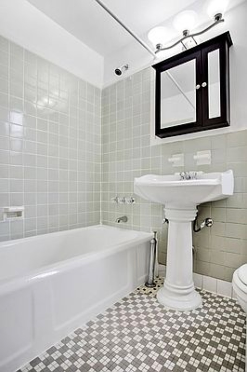 79-01 35th Avenue, Unit 4F Queens, NY 11372 - Photo 9 of 11 a bathroom with a sink a toilet and shower