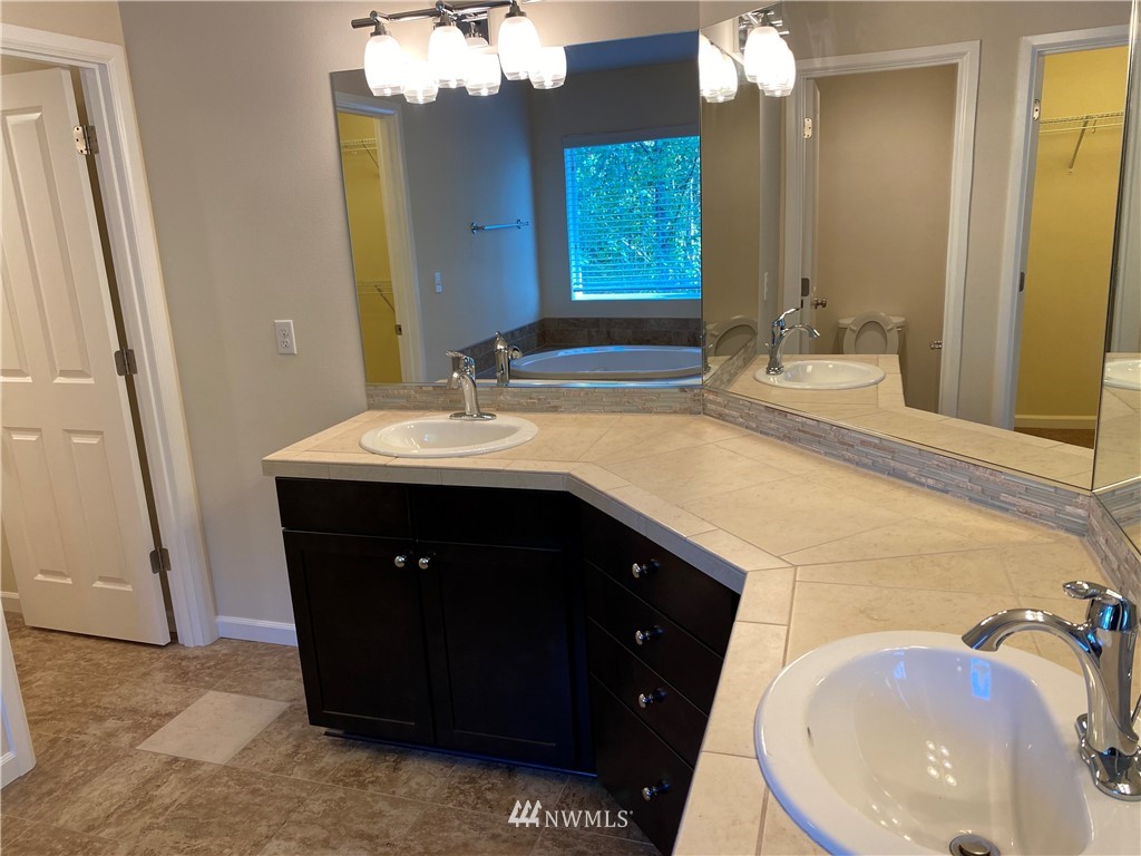 3406 176th Place Southeast Bothell, WA 98012 - Photo 11 of 19 a bathroom with a sink vanity and a mirror