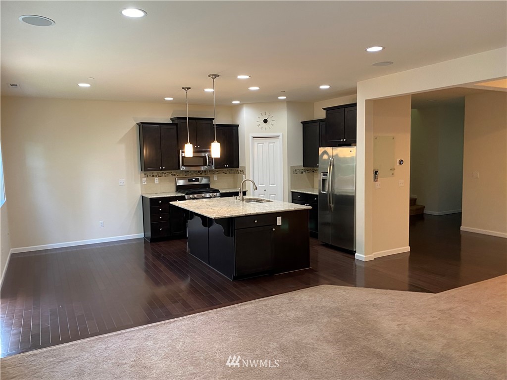 3406 176th Place Southeast Bothell, WA 98012 - Photo 4 of 19 a kitchen with a refrigerator and a sink