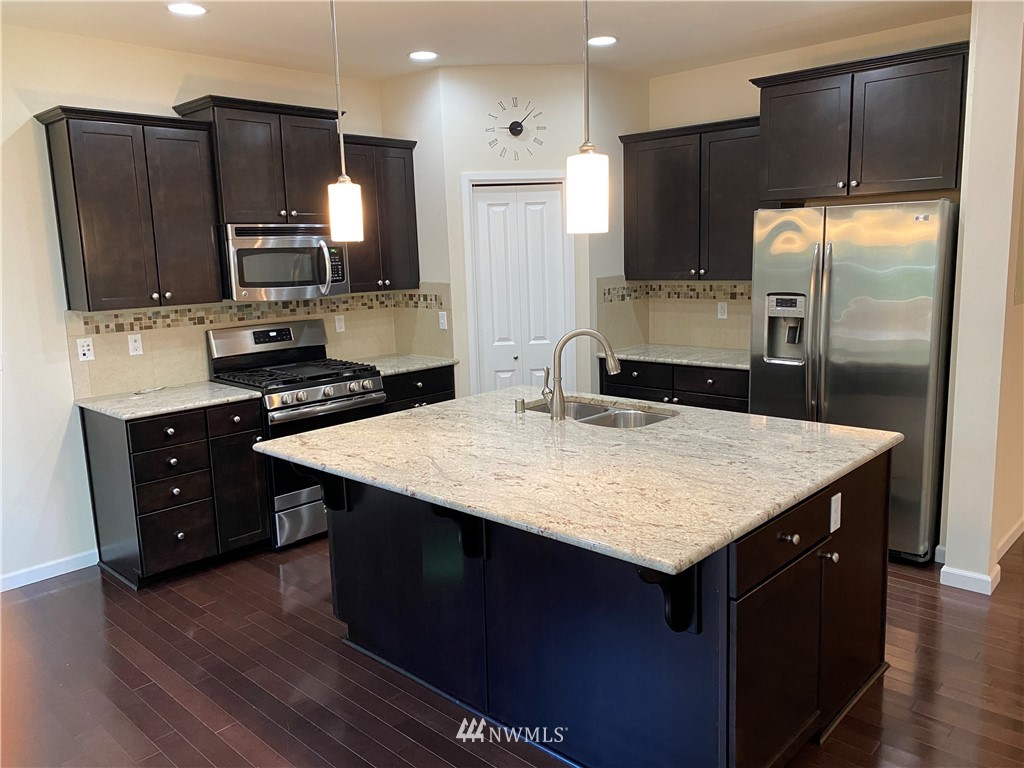 3406 176th Place Southeast Bothell, WA 98012 - Photo 5 of 19 a kitchen with a refrigerator sink and microwave