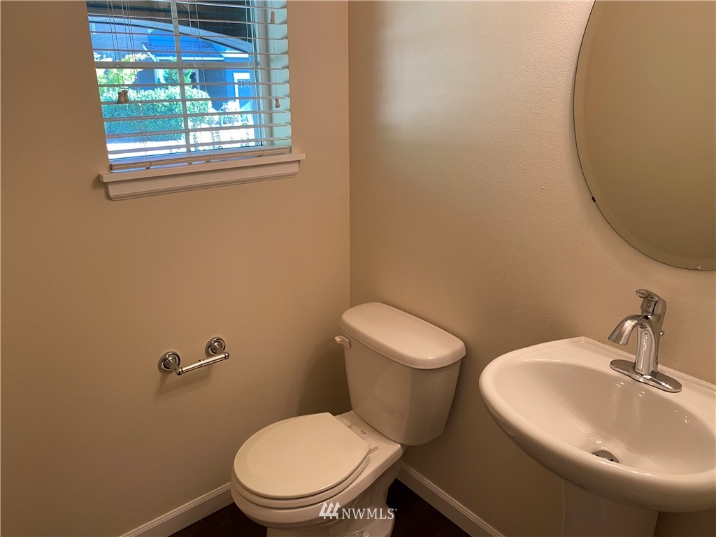 3406 176th Place Southeast Bothell, WA 98012 - Photo 8 of 19 a white toilet sitting next to a bathroom sink
