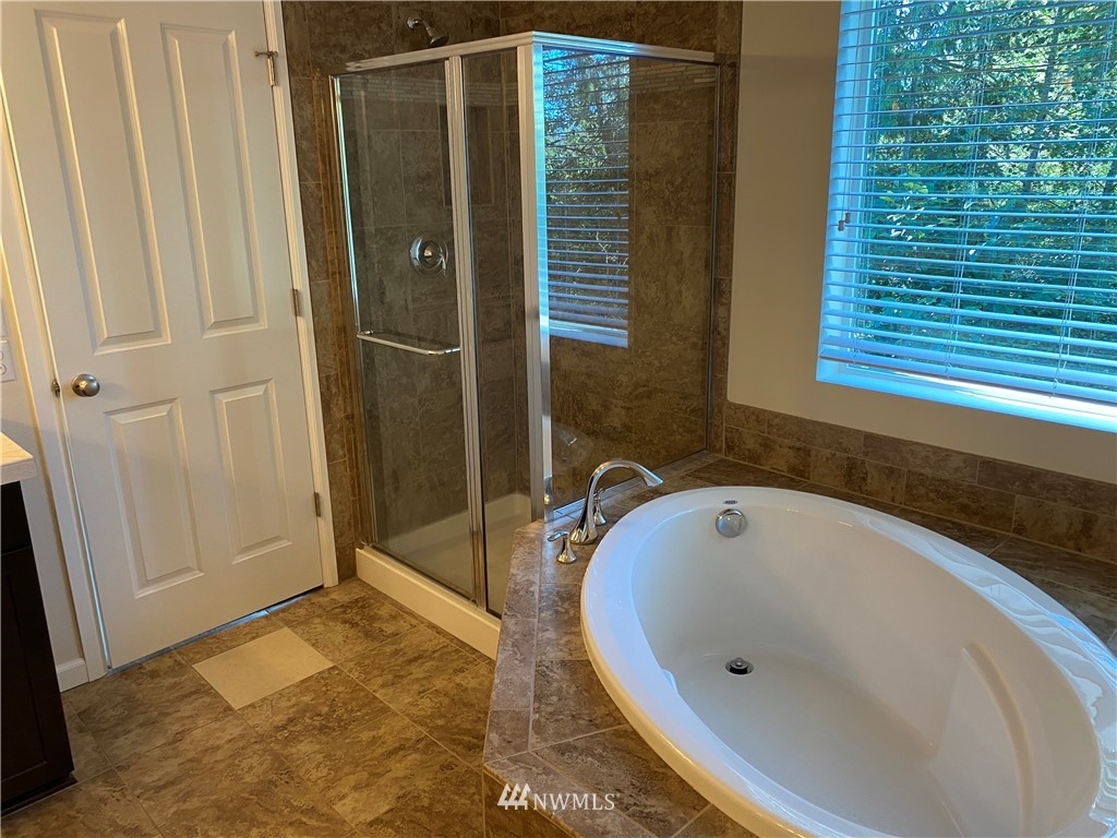3406 176th Place Southeast Bothell, WA 98012 - Photo 10 of 19 a bathroom with a tub and shower