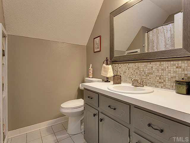 5229 Guess Road Durham, NC 27712 - Photo 20 of 25 Upstairs full bathroom is perfectly situated between both bedrooms. Updates include tile backsplash, mirror, and tile floors. Bathroom